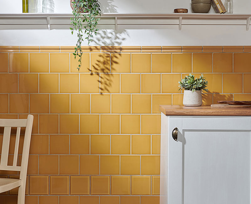 Une salle à manger avec un carrelage mural jaune tournesol